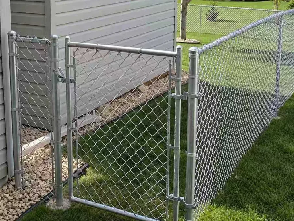 Galvanized chain link fence and gate around a residential yard