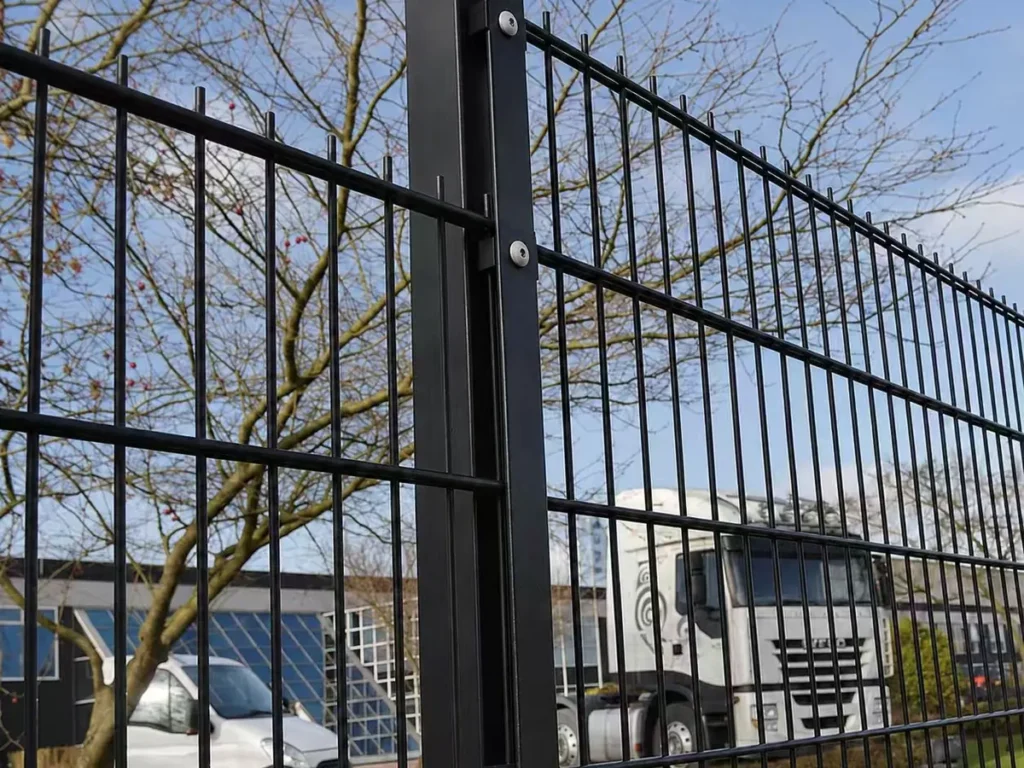 Black double wire mesh fence panels fixed to a square post