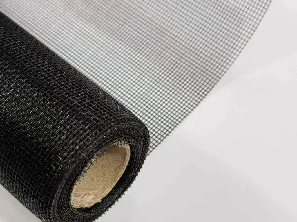 Black fiberglass screen roll on a paper core