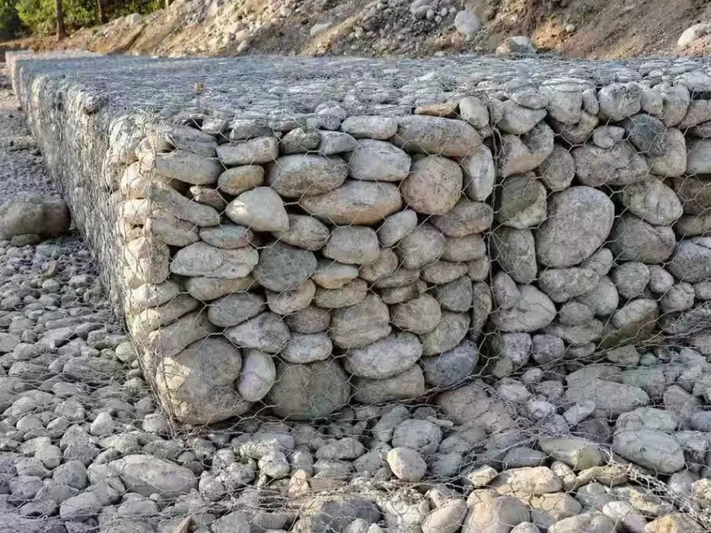 Stone-filled gabion boxes forming a riverside retaining wall